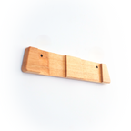 A light natural wood wall-mounted hook rack with three slots and two visible screw holes, shown against a plain white background.