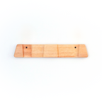A light natural wood ski rack or board with two small pre-drilled holes, shown against a plain white background.